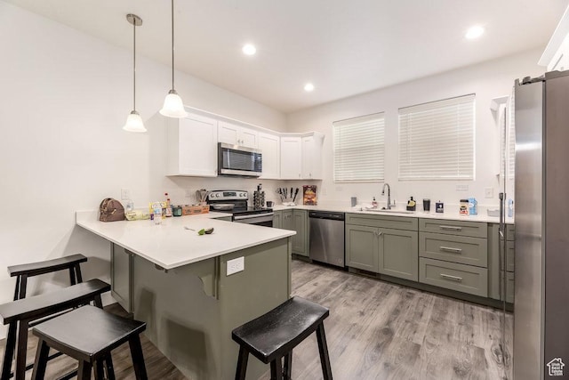 3833 W 1960 N, Lehi, UT 84043 - kitchen featuring a sink, appliances with stainless steel finishes, a kitchen bar, a peninsula, and white cabinetry