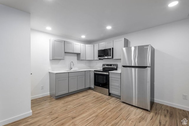3833 W 1960 N, Lehi, UT 84043 - kitchen with stainless steel appliances, light wood-style flooring, a sink, and gray cabinets