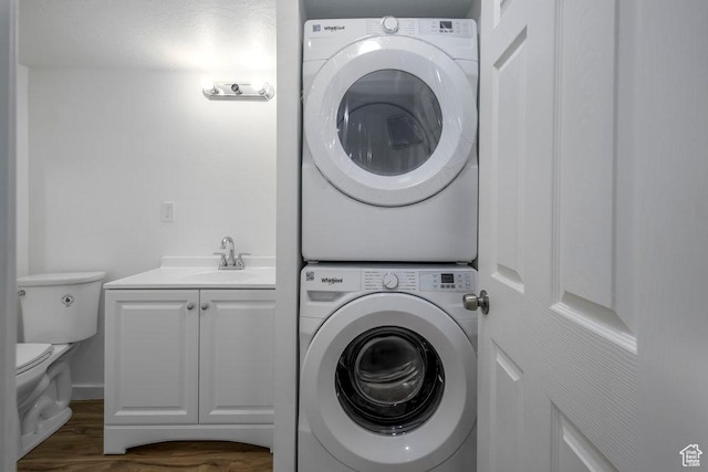 3833 W 1960 N, Lehi, UT 84043 - clothes washing area with stacked washing maching and dryer, dark wood-style floors, and a sink