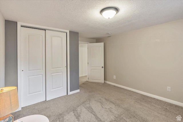3165 S 2000 E, Millcreek, UT 84109 - unfurnished bedroom with a closet, baseboards, carpet, and a textured ceiling