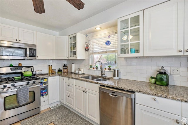 3165 S 2000 E, Millcreek, UT 84109 - kitchen with white cabinets, a sink, and appliances with stainless steel finishes