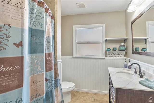 3165 S 2000 E, Millcreek, UT 84109 - full bath featuring vanity, tile patterned flooring, visible vents, a wainscoted wall, and toilet