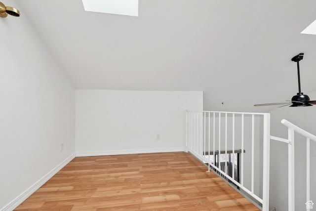 6831 N 2200 W Unit 12K, Park City, UT 84098 - additional living space with vaulted ceiling with skylight, baseboards, light wood-type flooring, and ceiling fan