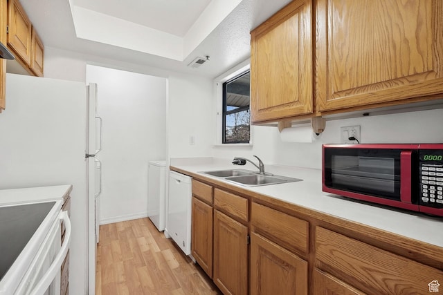 6831 N 2200 W Unit 12K, Park City, UT 84098 - kitchen featuring stove, light countertops, a sink, white dishwasher, and light wood finished floors