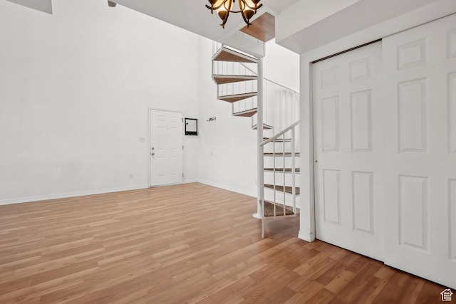 6831 N 2200 W Unit 12K, Park City, UT 84098 - foyer entrance featuring a high ceiling, light wood-type flooring, a chandelier, and stairway