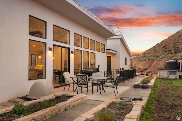 160 W Pebble, Rockville, UT 84763 - patio terrace at dusk featuring outdoor dining area and fence