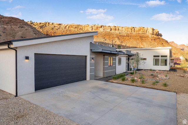 160 W Pebble, Rockville, UT 84763 - contemporary home with an attached garage, a mountain view, solar panels, and stucco siding
