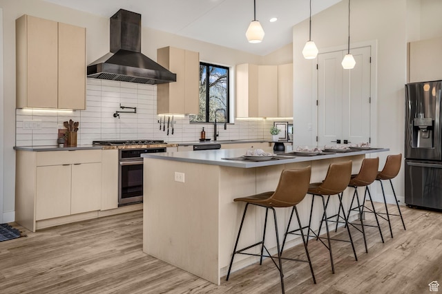 160 W Pebble, Rockville, UT 84763 - kitchen featuring appliances with stainless steel finishes, wall chimney exhaust hood, a center island, light wood finished floors, and decorative backsplash