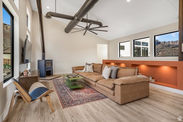 160 W Pebble, Rockville, UT 84763 - living room featuring baseboards, wood finished floors, ceiling fan, a wood stove, and high vaulted ceiling