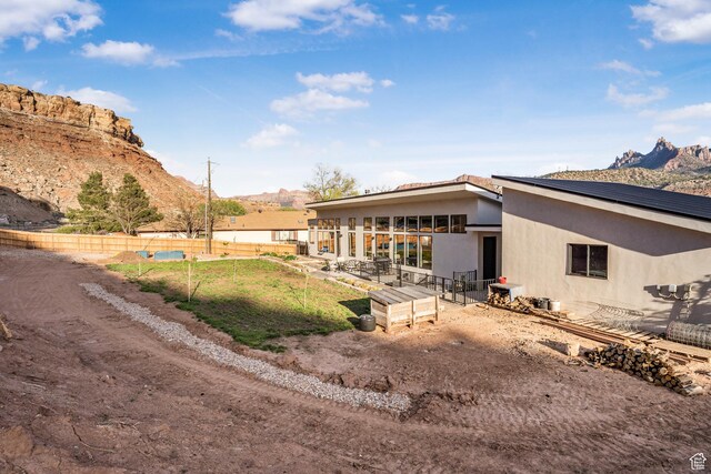 160 W Pebble, Rockville, UT 84763 - back of house featuring stucco siding, a mountain view, and a patio area