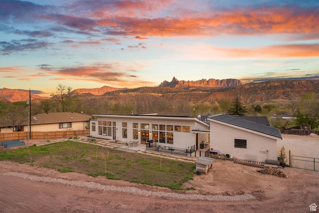 160 W Pebble, Rockville, UT 84763 - back of property featuring a mountain view, a patio area, a fenced backyard, stucco siding, and metal roof