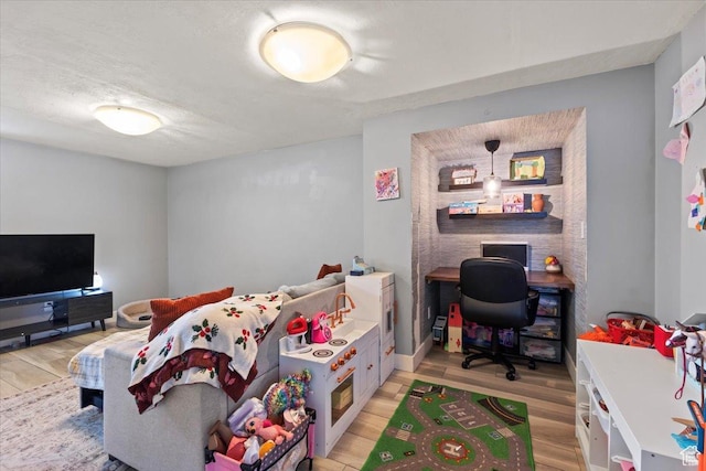 bedroom featuring light wood-style flooring and baseboards