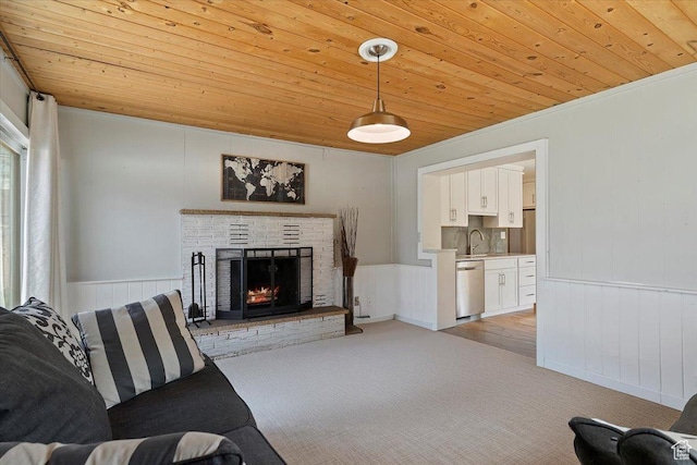 living room featuring wooden ceiling, light colored carpet, and a fireplace