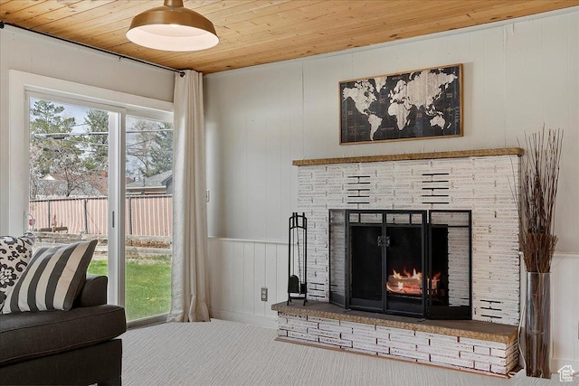 room details featuring wooden ceiling, carpet, and a fireplace