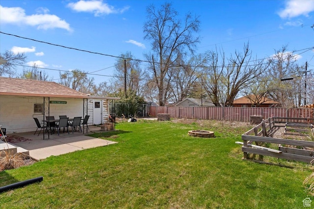 view of yard with a patio area, a fenced backyard, and an outdoor fire pit