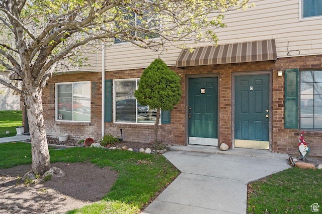 property entrance with brick siding