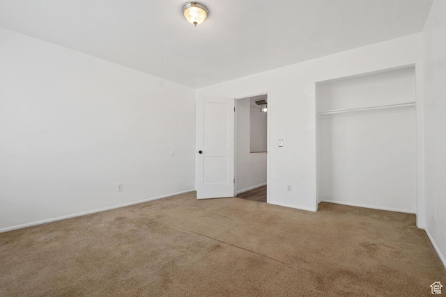 unfurnished bedroom with a closet, baseboards, and carpet