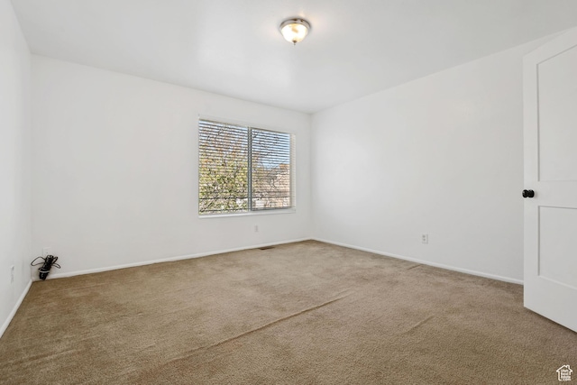 carpeted spare room with baseboards