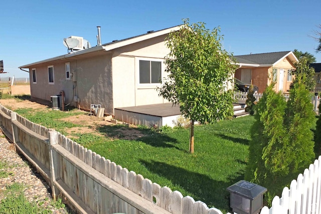 1653 N Cedar Blvd, Cedar City, UT 84721 - back of house featuring stucco siding, a wooden deck, and a lawn