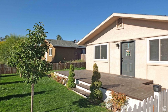 1653 N Cedar Blvd, Cedar City, UT 84721 - exterior space with a yard, a wooden deck, stucco siding, and fence