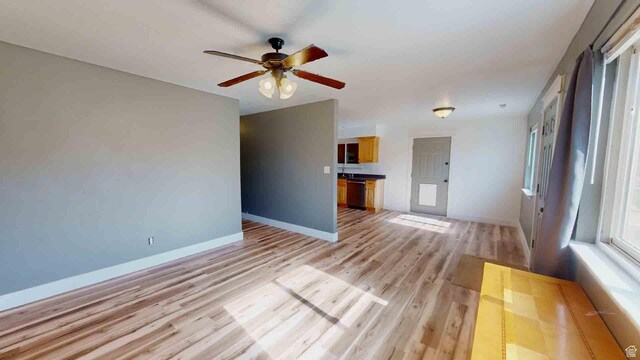 1653 N Cedar Blvd, Cedar City, UT 84721 - unfurnished living room with light wood finished floors, baseboards, and a ceiling fan