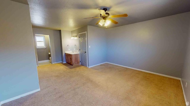 1653 N Cedar Blvd, Cedar City, UT 84721 - empty room with light carpet, a sink, baseboards, and a ceiling fan