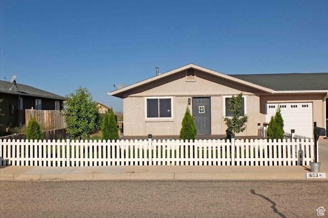 1653 N Cedar Blvd, Cedar City, UT 84721 - view of front of home featuring a garage, stucco siding, concrete driveway, and a fenced front yard