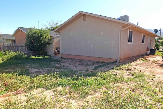 1653 N Cedar Blvd, Cedar City, UT 84721 - view of side of property with stucco siding, cooling unit, and fence