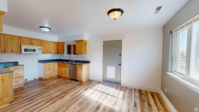 1653 N Cedar Blvd, Cedar City, UT 84721 - kitchen with visible vents, white microwave, light wood-style floors, and dishwasher