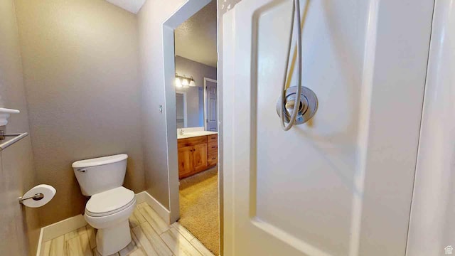 1653 N Cedar Blvd, Cedar City, UT 84721 - bathroom with toilet, vanity, and baseboards
