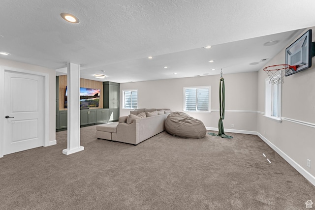 unfurnished living room featuring a textured ceiling, baseboards, carpet, and recessed lighting
