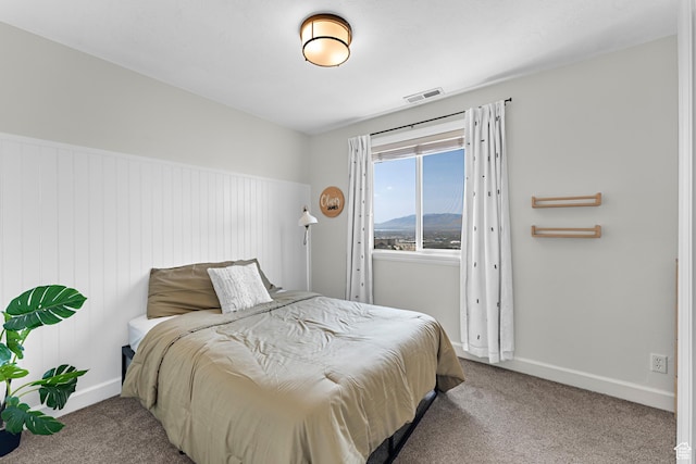 carpeted bedroom with baseboards and visible vents
