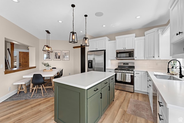 kitchen featuring green cabinets, white cabinetry, a sink, and appliances with stainless steel finishes