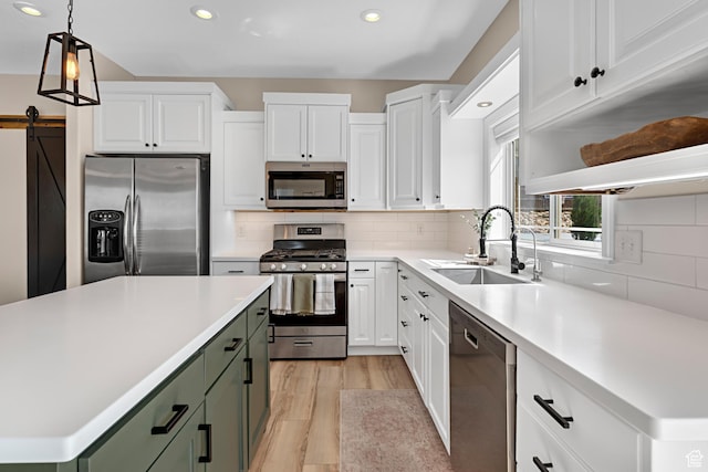 kitchen featuring light countertops, white cabinetry, a sink, and appliances with stainless steel finishes