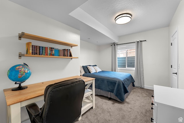 bedroom featuring baseboards and light carpet
