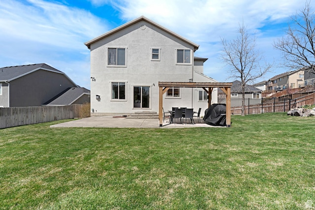 back of house featuring a patio area, a fenced backyard, a lawn, and stucco siding