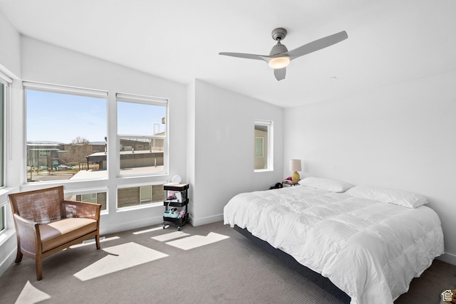 carpeted bedroom featuring ceiling fan and baseboards