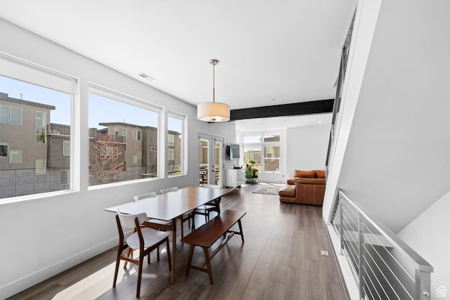 dining area featuring visible vents, baseboards, and wood finished floors