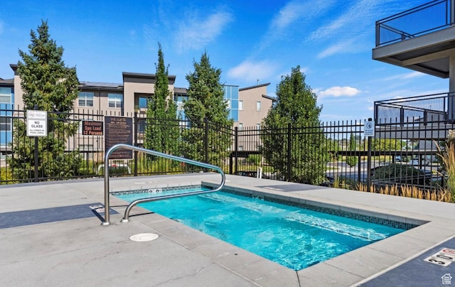 view of pool with fence