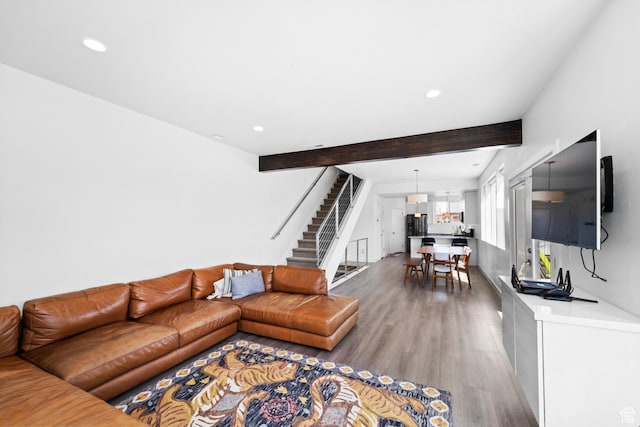 living room with recessed lighting, stairs, beamed ceiling, and wood finished floors