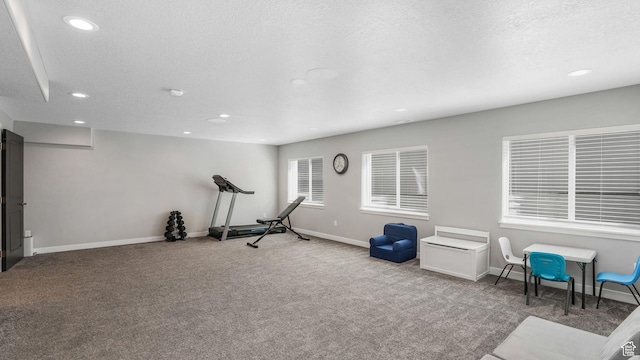 exercise area featuring recessed lighting, baseboards, a textured ceiling, and carpet floors