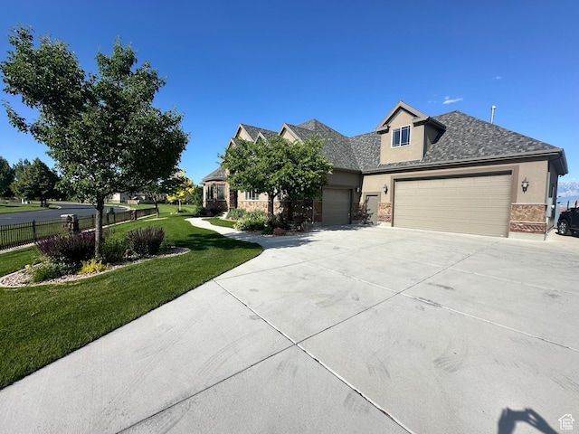 1234 S Parkway Blvd E Unit 725, Saratoga Springs, UT 84045 - view of front facade with a front yard, an attached garage, fence, concrete driveway, and stucco siding