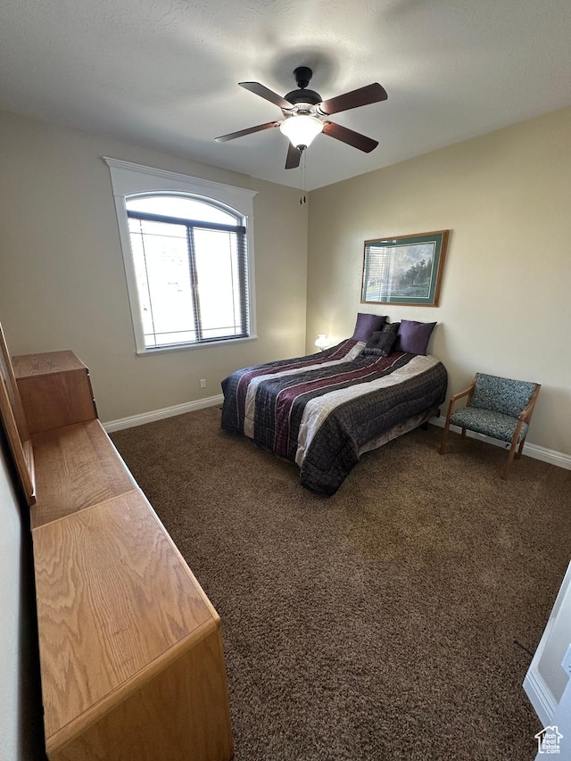 1234 S Parkway Blvd E Unit 725, Saratoga Springs, UT 84045 - bedroom featuring baseboards, dark carpet, and ceiling fan