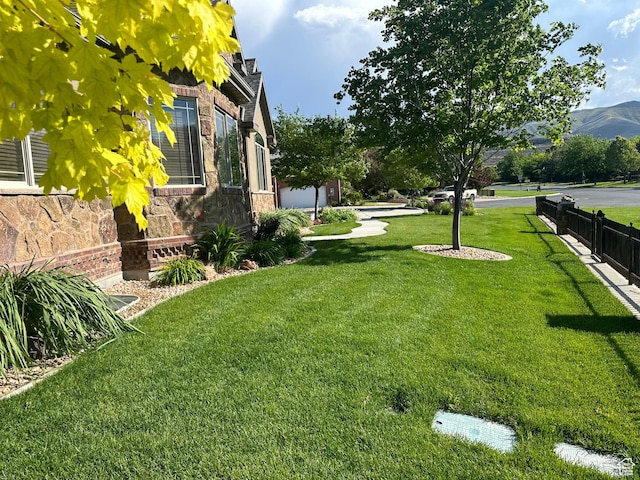 1234 S Parkway Blvd E Unit 725, Saratoga Springs, UT 84045 - view of yard with a mountain view and fence