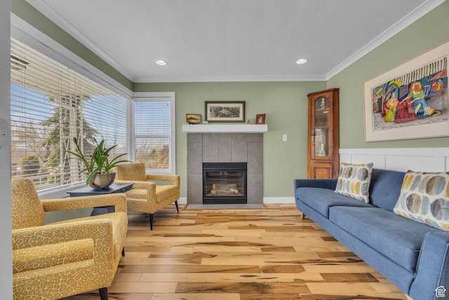 2895 E Wardway Dr S, Salt Lake City, UT 84124 - living area with light wood finished floors, crown molding, a tiled fireplace, recessed lighting, and baseboards