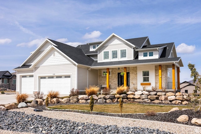 159 E 625 S, Mantua, UT 84324 - view of front of home with a porch, driveway, an attached garage, stone siding, and roof with shingles