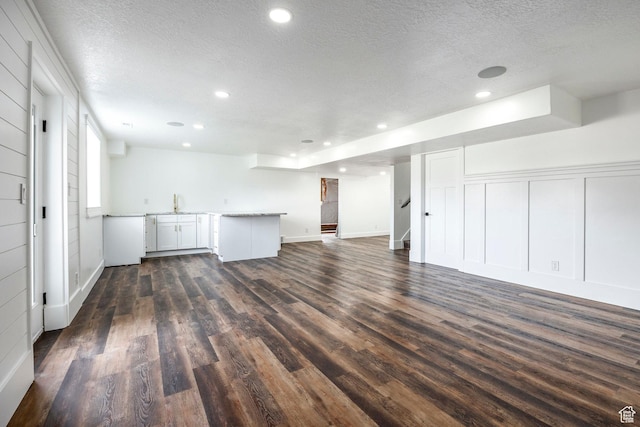 159 E 625 S, Mantua, UT 84324 - unfurnished living room featuring a textured ceiling, dark wood-type flooring, stairway, recessed lighting, and a sink