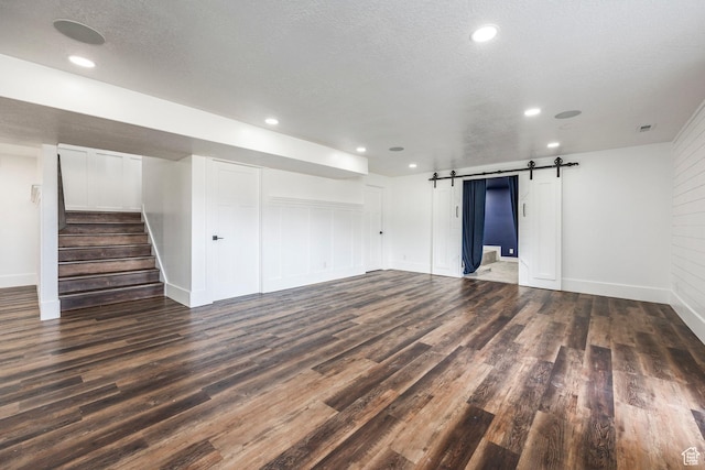 159 E 625 S, Mantua, UT 84324 - spare room featuring dark wood finished floors, a barn door, baseboards, stairs, and recessed lighting