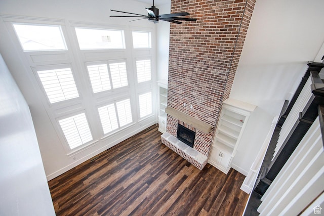 159 E 625 S, Mantua, UT 84324 - unfurnished living room featuring a fireplace, ceiling fan, dark wood-type flooring, and baseboards