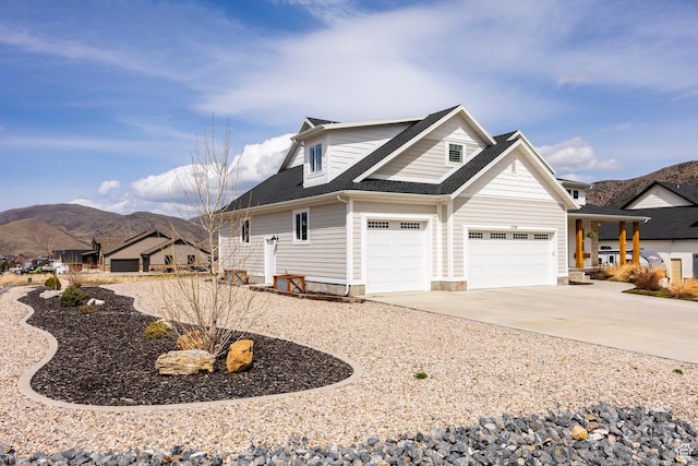 159 E 625 S, Mantua, UT 84324 - view of side of property with a mountain view, concrete driveway, a shingled roof, and a garage